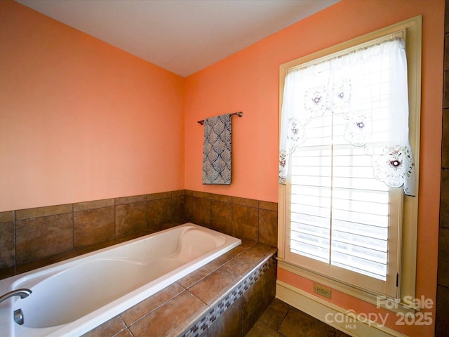 bathroom with tile patterned floors and tiled tub