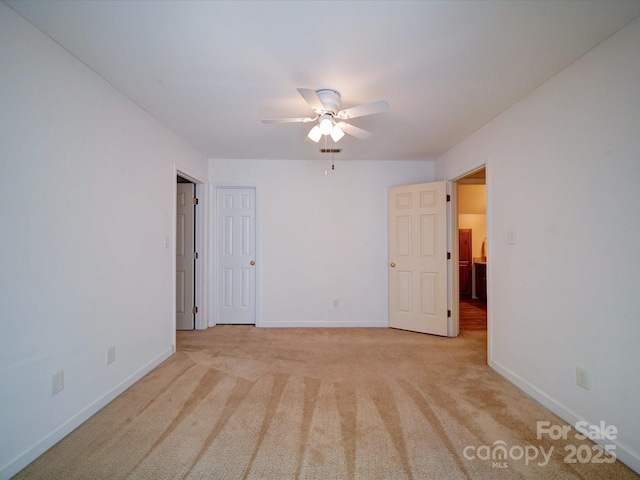 carpeted empty room featuring ceiling fan