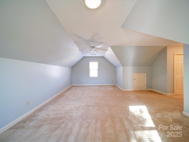 bonus room with ceiling fan, light carpet, and vaulted ceiling