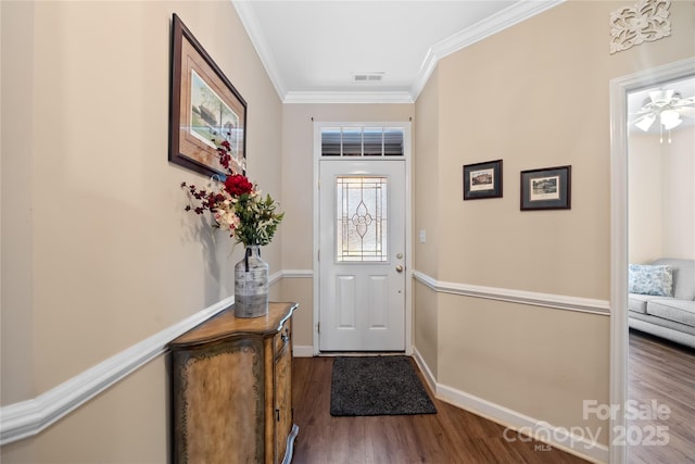 doorway to outside with ornamental molding and dark wood-type flooring