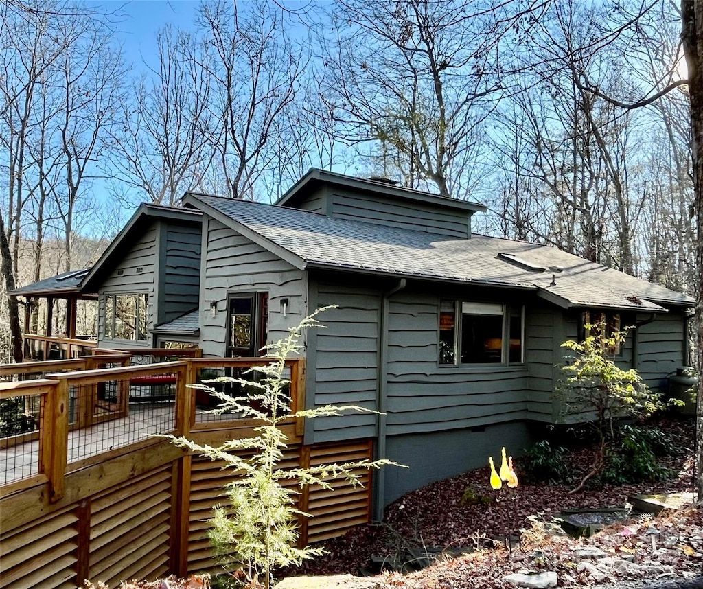 view of side of home with a deck