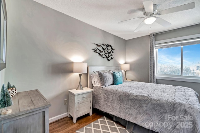 bedroom featuring hardwood / wood-style floors, a textured ceiling, and ceiling fan