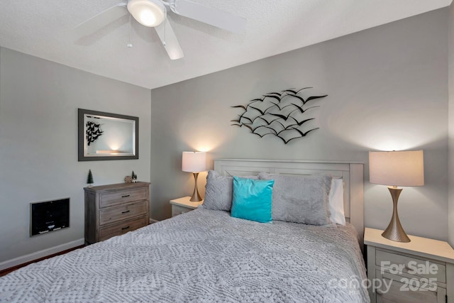 bedroom with a textured ceiling and ceiling fan