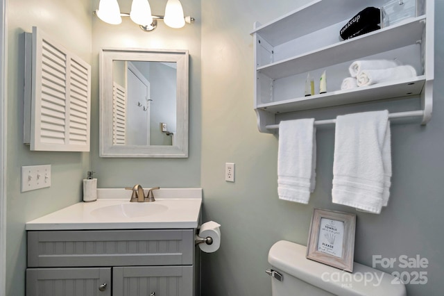 bathroom featuring vanity and toilet