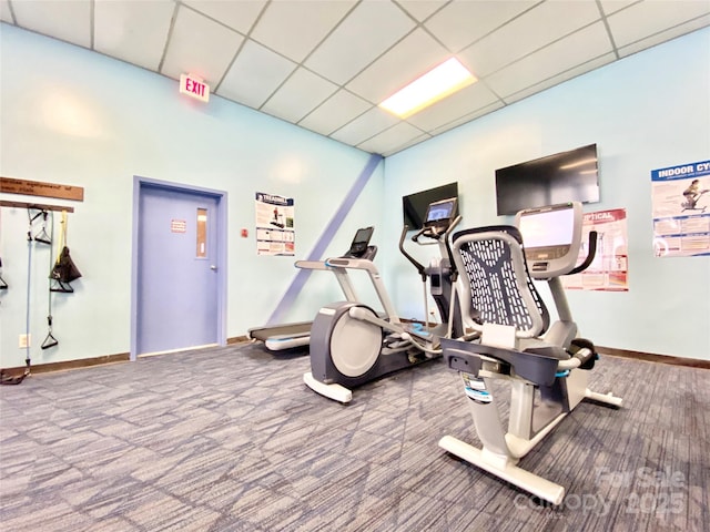 workout area featuring carpet flooring and a drop ceiling