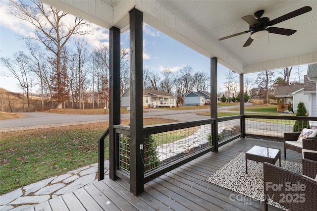 deck featuring ceiling fan and a porch