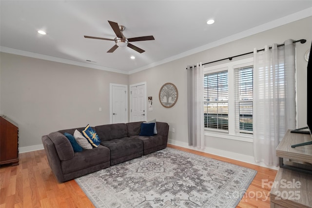 living room with ceiling fan, light hardwood / wood-style floors, and ornamental molding