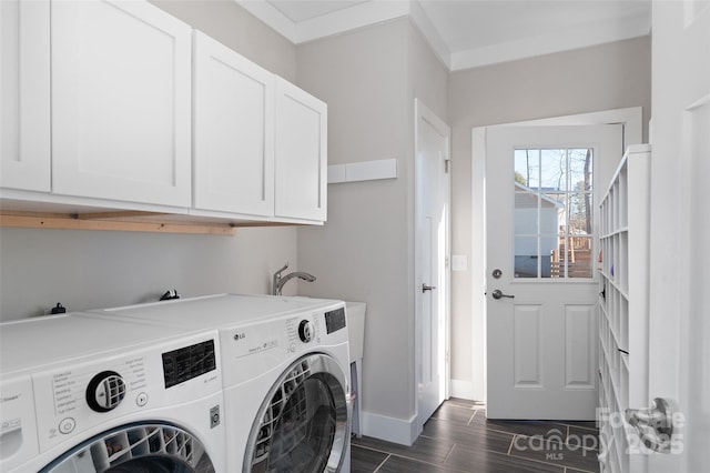 washroom featuring washer and dryer, cabinets, and ornamental molding