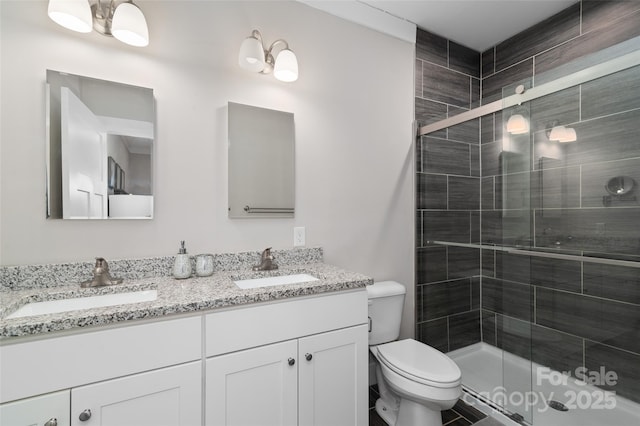 bathroom featuring vanity, toilet, and an enclosed shower