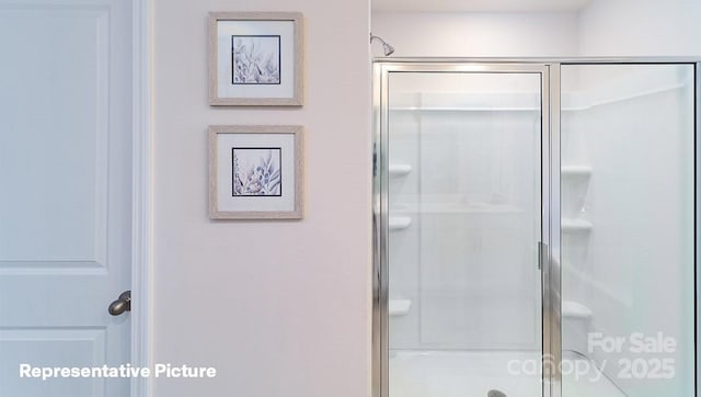 bathroom with a shower with shower door