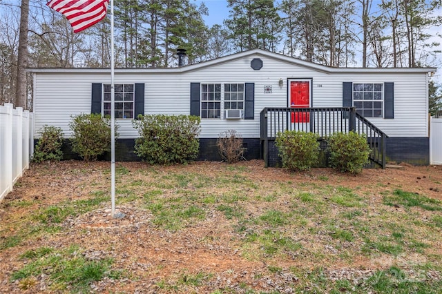 manufactured / mobile home with cooling unit, fence, and a wooden deck