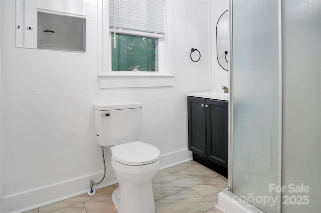 bathroom featuring vanity, an enclosed shower, and toilet