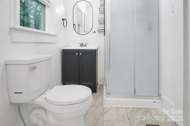 bathroom featuring vanity, toilet, and walk in shower