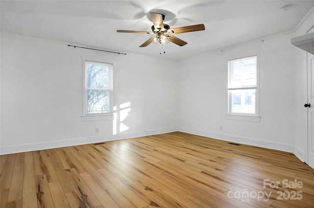 empty room featuring ceiling fan, light hardwood / wood-style floors, and ornamental molding