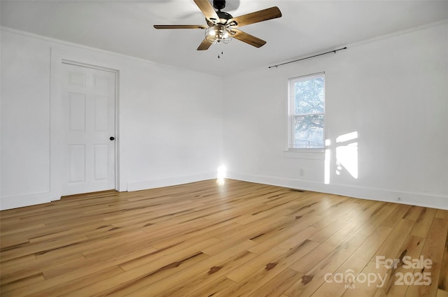 unfurnished room featuring ceiling fan, light hardwood / wood-style flooring, and crown molding