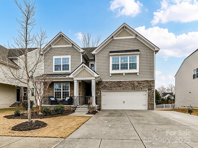 craftsman inspired home featuring a garage and a porch