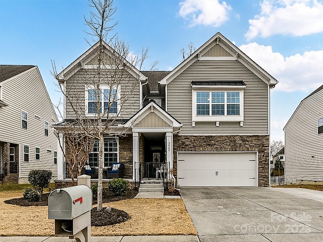 view of front of house featuring a garage and a porch