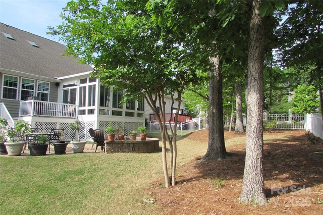 view of yard featuring a fenced backyard and a sunroom