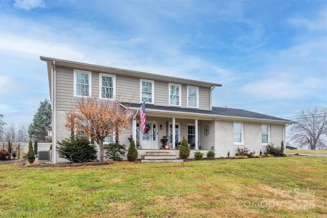 view of front of property featuring a front lawn and a porch