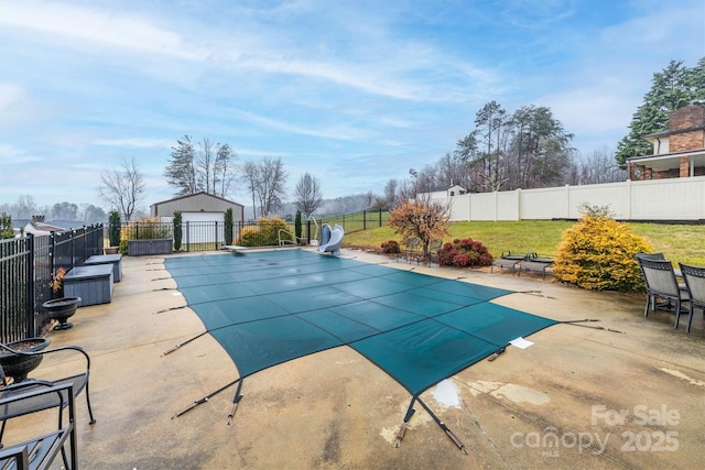 view of pool with a yard, a water slide, and a patio