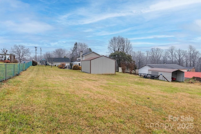 view of yard with a carport and a storage shed