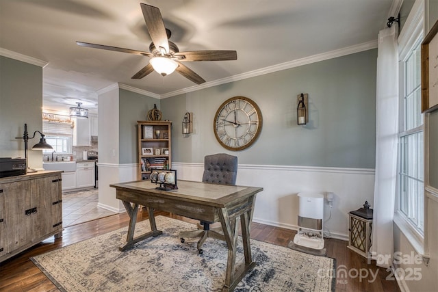 office space featuring light wood-type flooring, ceiling fan, and crown molding