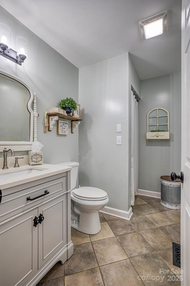 bathroom featuring toilet and vanity