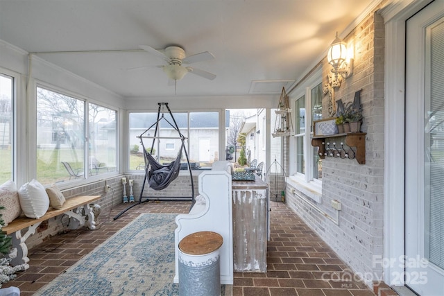 sunroom / solarium featuring ceiling fan