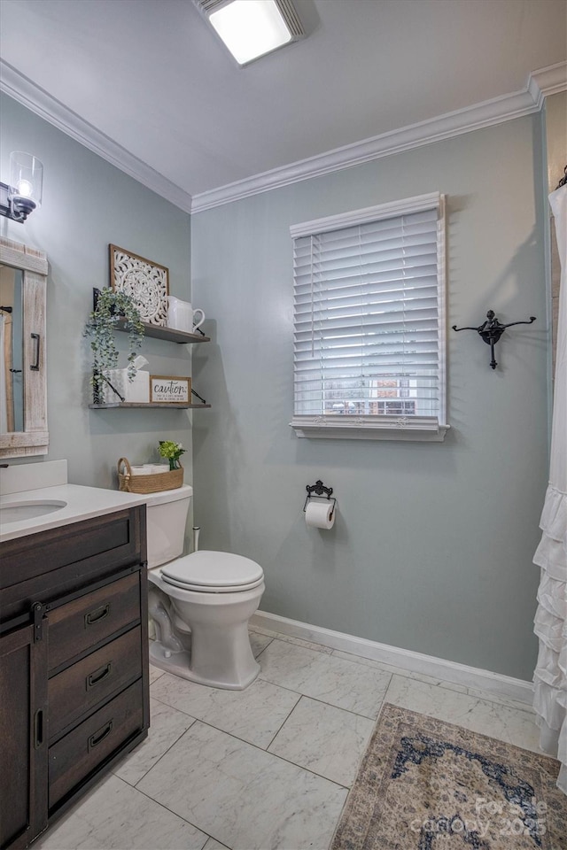 bathroom featuring toilet, vanity, and crown molding