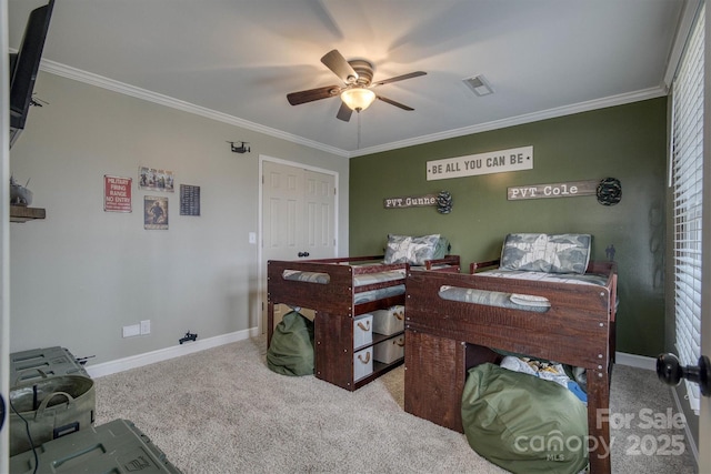 bedroom with ceiling fan, light colored carpet, a closet, and crown molding