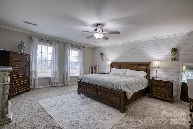 carpeted bedroom with ceiling fan, crown molding, and wood walls