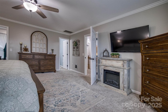 carpeted bedroom featuring ceiling fan and crown molding