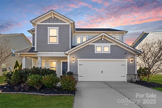 craftsman-style home with a yard and a garage