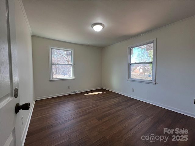 unfurnished room featuring crown molding, dark wood-type flooring, visible vents, and a healthy amount of sunlight