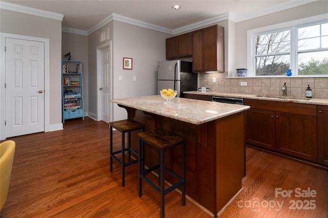 kitchen with dark hardwood / wood-style flooring, sink, a center island, and appliances with stainless steel finishes