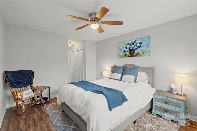 bedroom with a closet, ceiling fan, and dark wood-type flooring