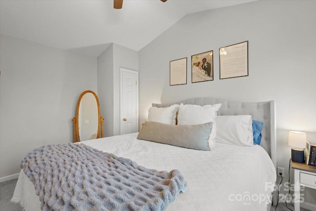 bedroom with carpet flooring, ceiling fan, and vaulted ceiling