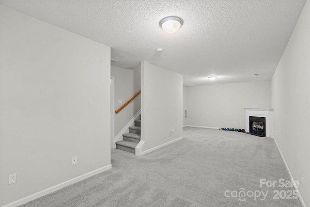 basement with a textured ceiling and light carpet