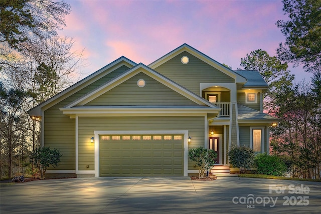 view of front of home featuring a balcony and a garage