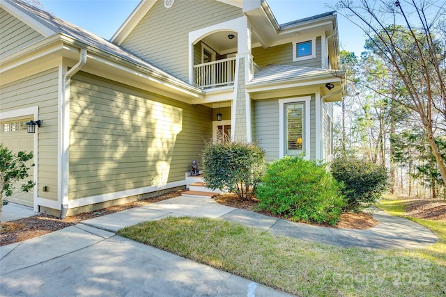 property entrance with a balcony and a garage