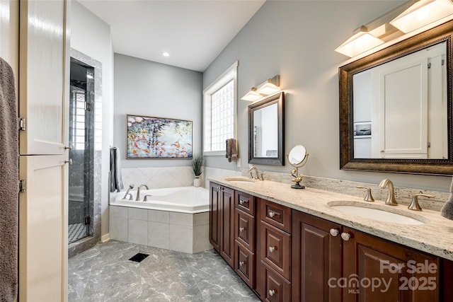 bathroom featuring vanity and independent shower and bath