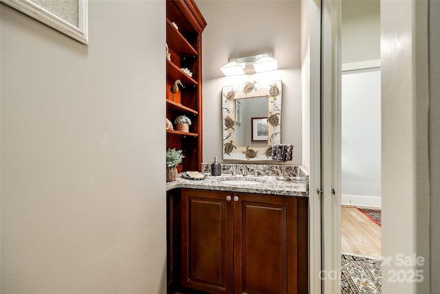 bathroom with vanity and wood-type flooring