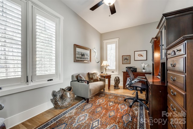 office space featuring ceiling fan, hardwood / wood-style floors, and lofted ceiling