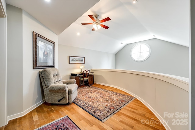 sitting room with hardwood / wood-style flooring, ceiling fan, and vaulted ceiling