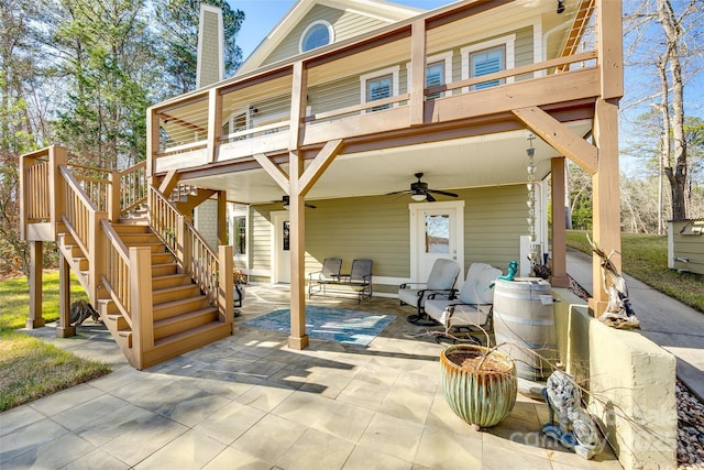 back of property with ceiling fan and a patio