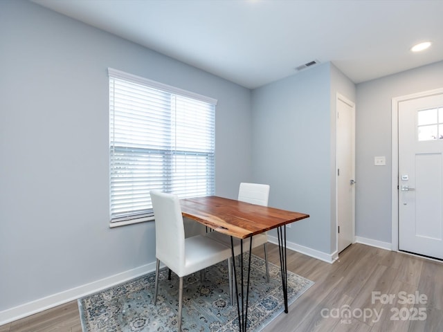 dining area with light wood-style floors, recessed lighting, visible vents, and baseboards