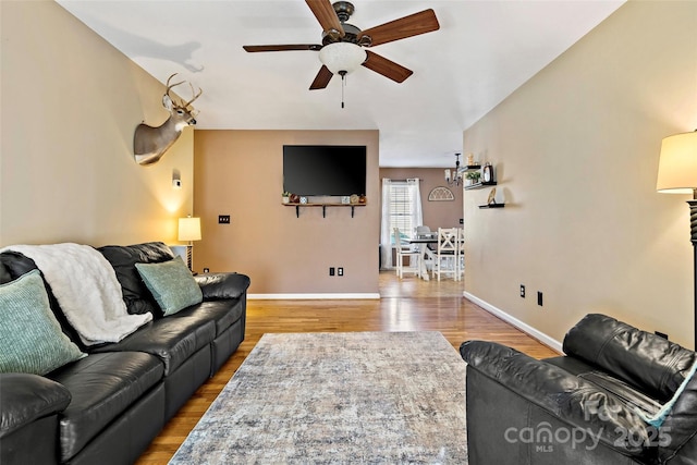 living room with hardwood / wood-style floors and ceiling fan