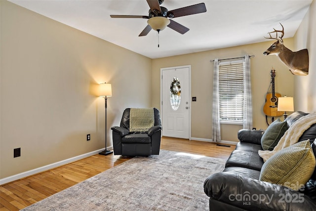 living room featuring ceiling fan and light wood-type flooring