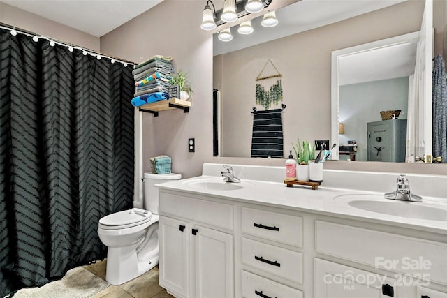 bathroom featuring tile patterned flooring, vanity, and toilet