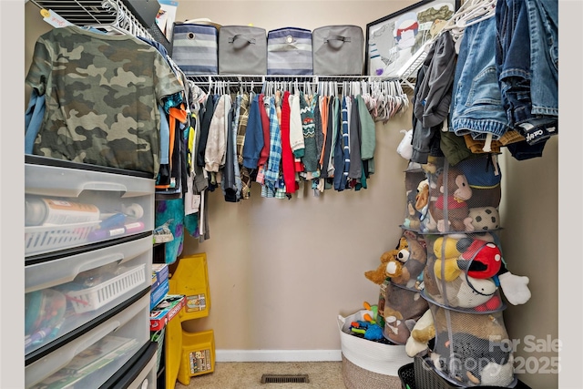 walk in closet featuring carpet